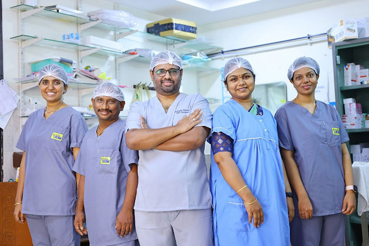 Medical team at Gouda ENT Hospital posing together in a clinical setting, wearing scrubs and surgical caps.